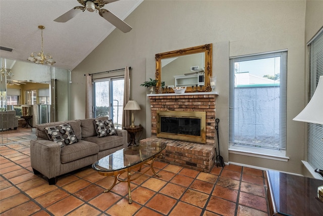 living room featuring tile patterned flooring, ceiling fan with notable chandelier, a fireplace, and high vaulted ceiling