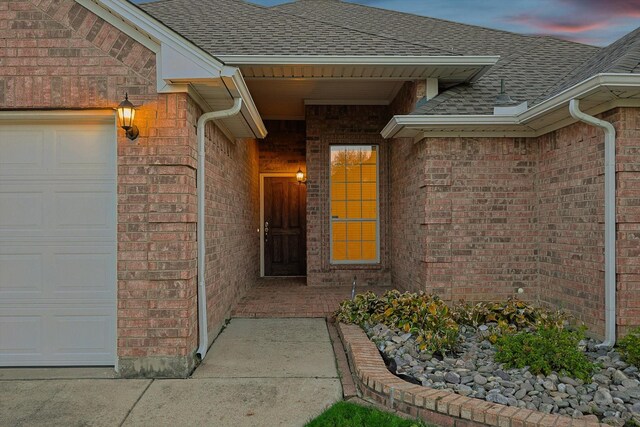 exterior entry at dusk with a garage