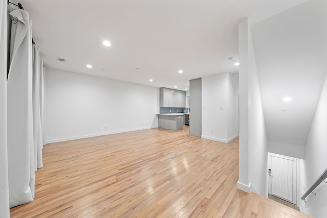 unfurnished living room with light wood-style flooring, recessed lighting, visible vents, and baseboards