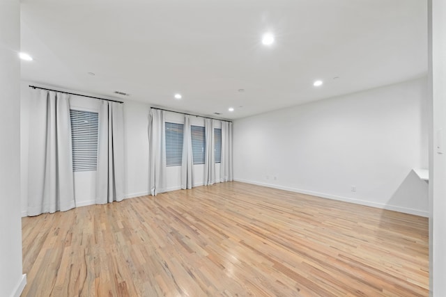 spare room with recessed lighting, visible vents, baseboards, and light wood-style flooring