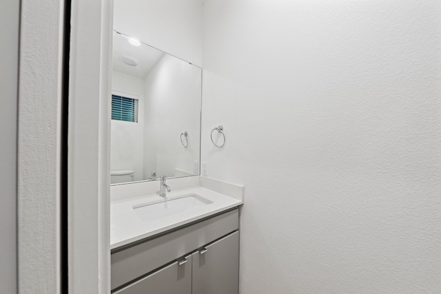 bathroom featuring toilet and vanity