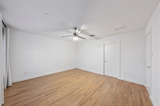 interior space featuring light wood-style floors, visible vents, and baseboards