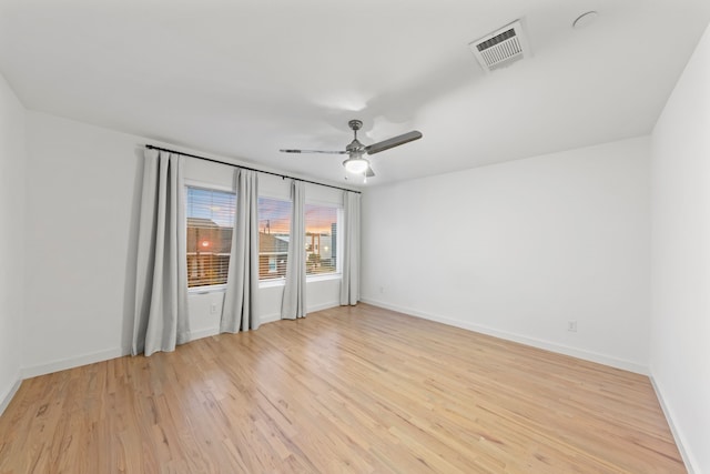 unfurnished room featuring visible vents, baseboards, light wood-style floors, and a ceiling fan