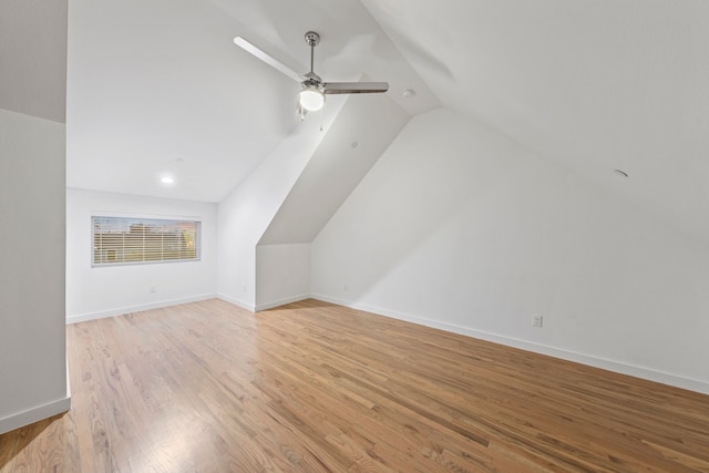 bonus room featuring lofted ceiling, light wood-style floors, baseboards, and ceiling fan