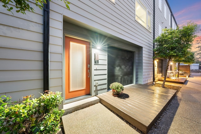 view of exterior entry featuring a wooden deck