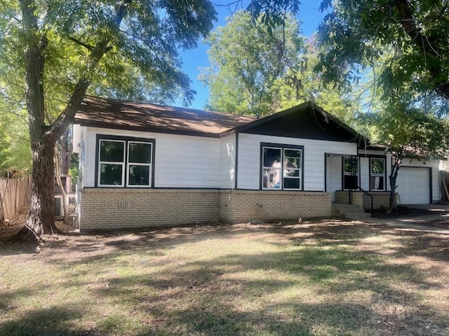 ranch-style house with a front lawn and a garage