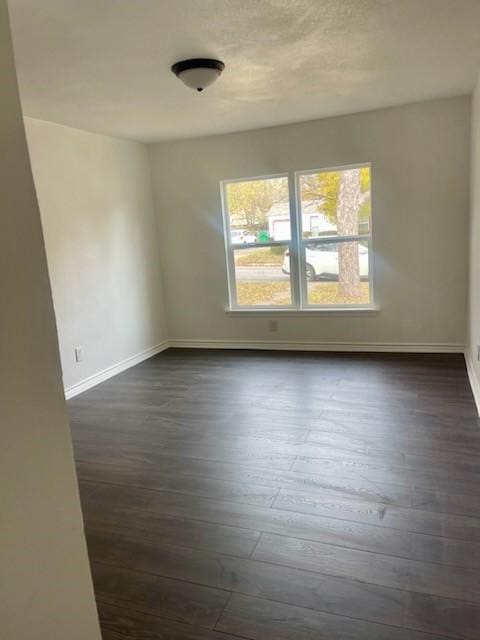 empty room featuring dark hardwood / wood-style floors