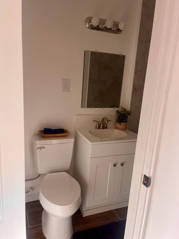 bathroom featuring tile patterned floors, vanity, and toilet