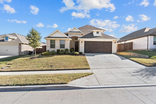 view of front of property featuring a garage and a front lawn