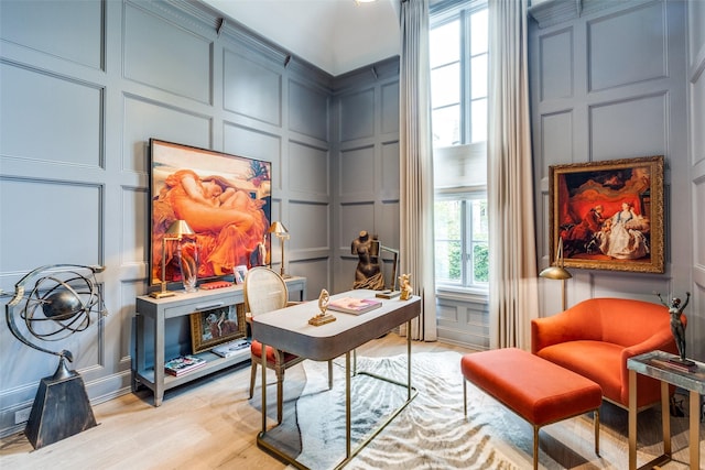 home office with light hardwood / wood-style flooring