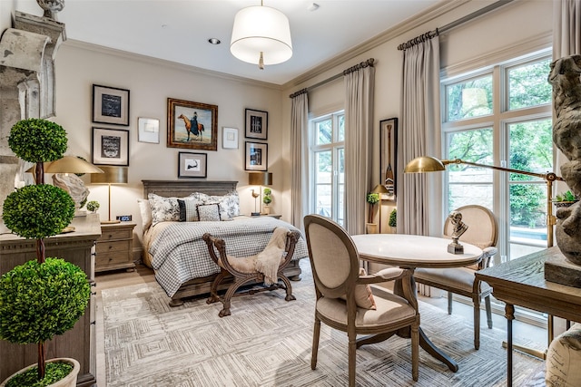 bedroom with ornamental molding, light hardwood / wood-style flooring, and multiple windows