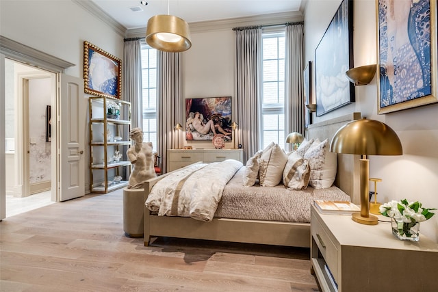 bedroom featuring light hardwood / wood-style flooring and ornamental molding