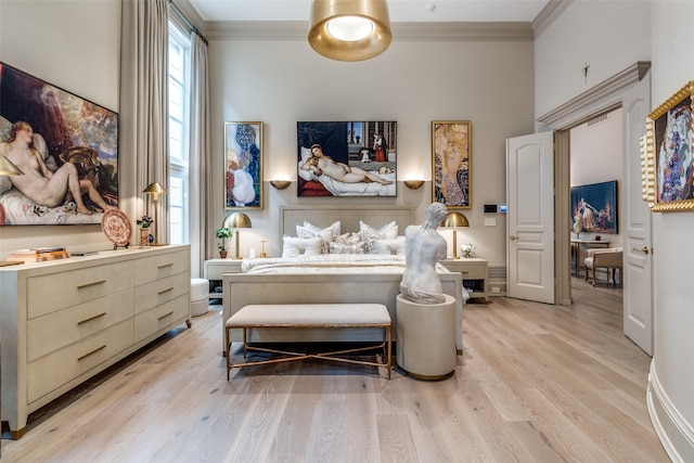 bedroom with light hardwood / wood-style floors and crown molding