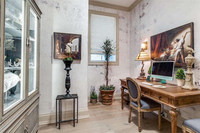 office with light hardwood / wood-style flooring and ornamental molding