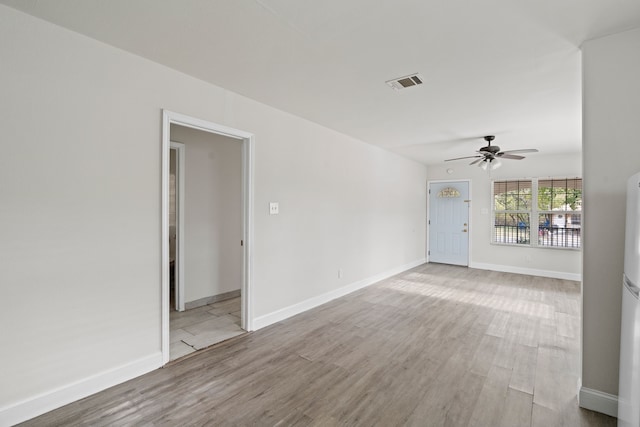 unfurnished living room with ceiling fan and light wood-type flooring