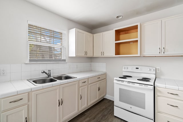 kitchen featuring tile counters, sink, dark hardwood / wood-style flooring, backsplash, and electric stove