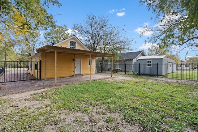 back of property with a lawn and a patio area