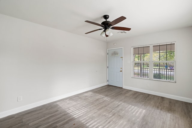 spare room featuring wood-type flooring and ceiling fan