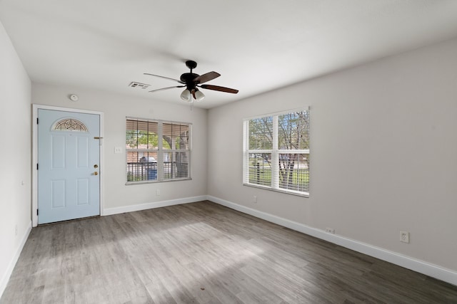 empty room with ceiling fan and hardwood / wood-style floors