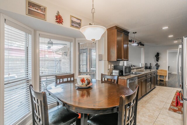 tiled dining room featuring sink