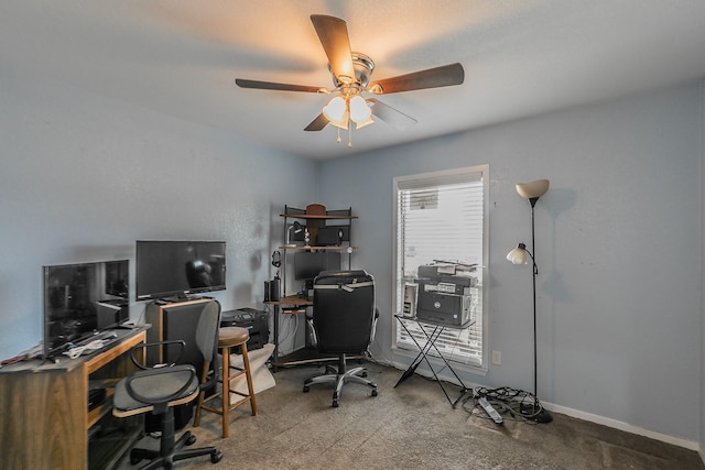 carpeted office space featuring ceiling fan