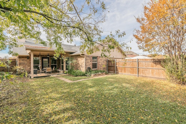 view of yard with ceiling fan and a patio area