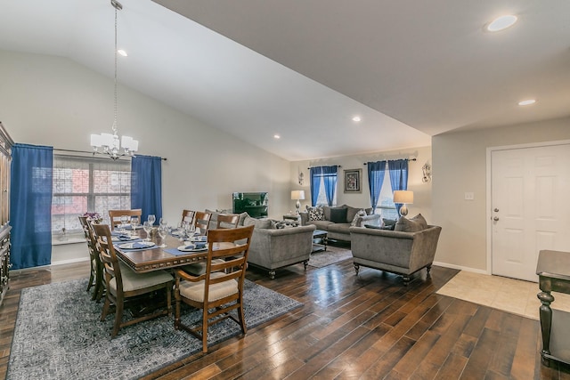 dining space featuring lofted ceiling, dark hardwood / wood-style floors, and an inviting chandelier