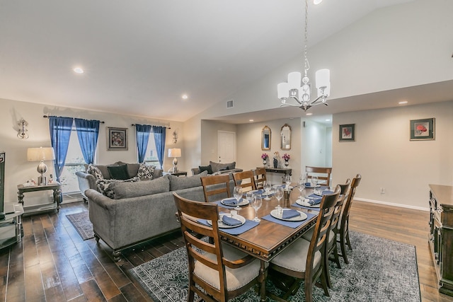 dining area with a notable chandelier, dark hardwood / wood-style flooring, and high vaulted ceiling