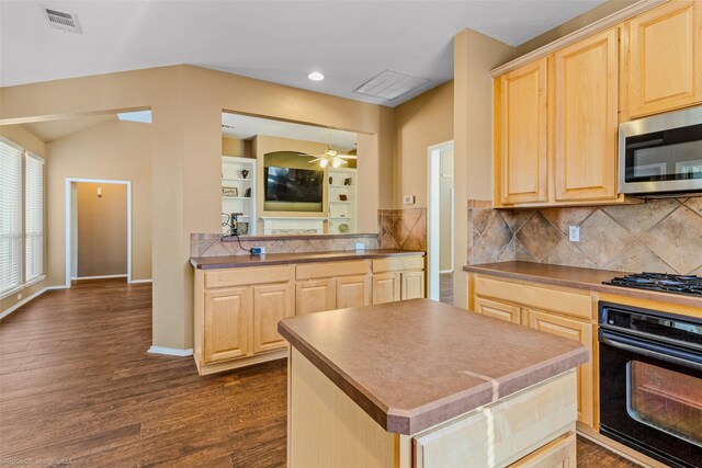 kitchen with dark hardwood / wood-style flooring, stainless steel appliances, and light brown cabinetry