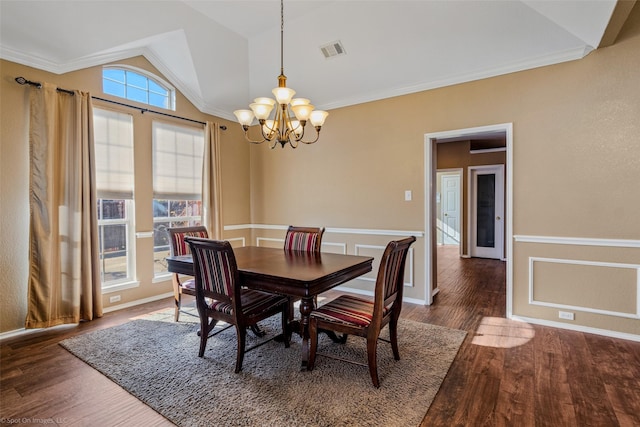 dining area featuring crown molding, dark hardwood / wood-style floors, vaulted ceiling, and a notable chandelier