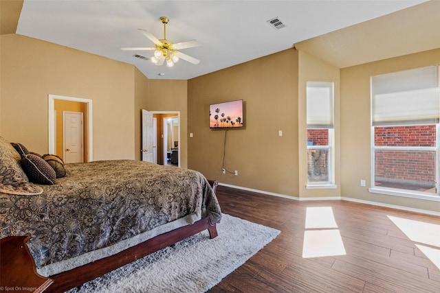 bedroom featuring ceiling fan, dark hardwood / wood-style floors, and vaulted ceiling