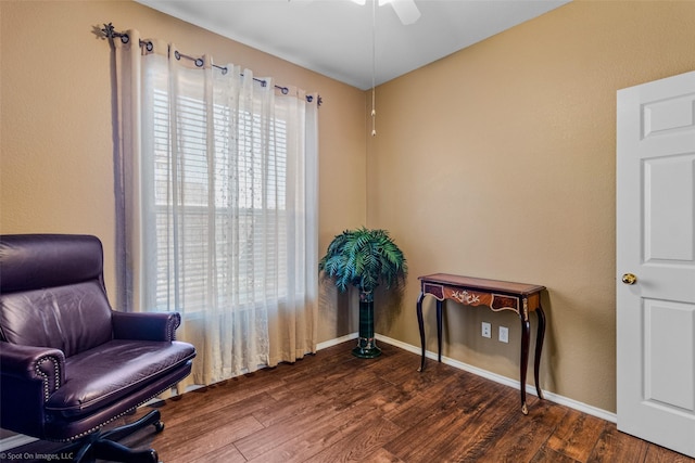 living area with dark hardwood / wood-style floors and ceiling fan