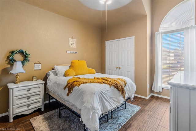 bedroom featuring dark hardwood / wood-style flooring and a closet