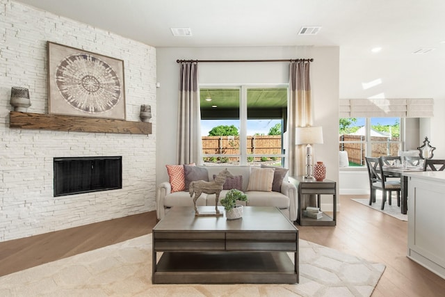 living room featuring a fireplace and light hardwood / wood-style flooring