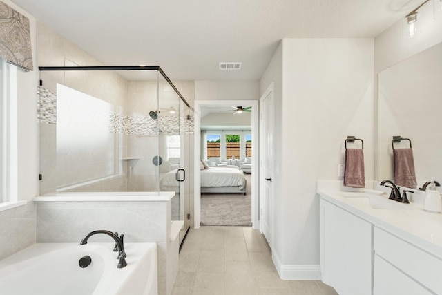 bathroom featuring vanity and independent shower and bath