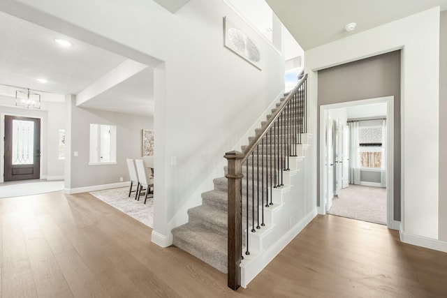 entryway with hardwood / wood-style flooring and an inviting chandelier