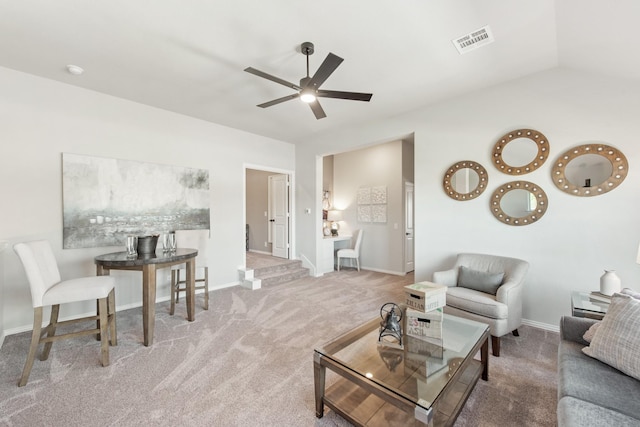 carpeted living room with vaulted ceiling and ceiling fan