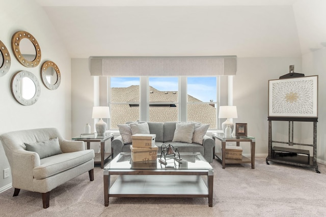 carpeted living room featuring vaulted ceiling