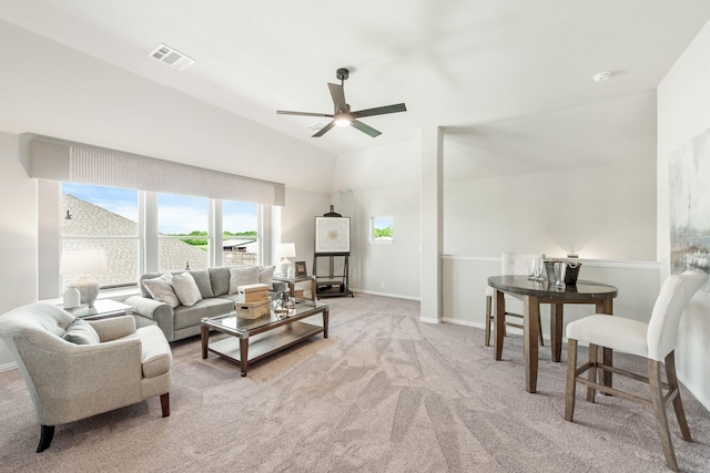 living room with ceiling fan, light colored carpet, and lofted ceiling