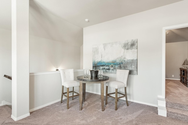 living area featuring vaulted ceiling and carpet floors