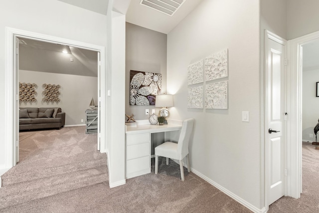 office featuring built in desk and light colored carpet