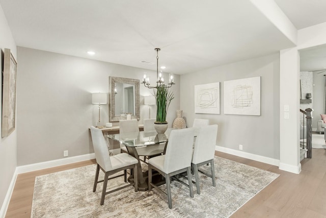 dining room featuring an inviting chandelier and light hardwood / wood-style floors