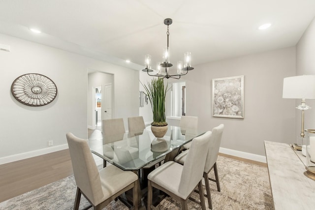 dining area with a chandelier and light wood-type flooring