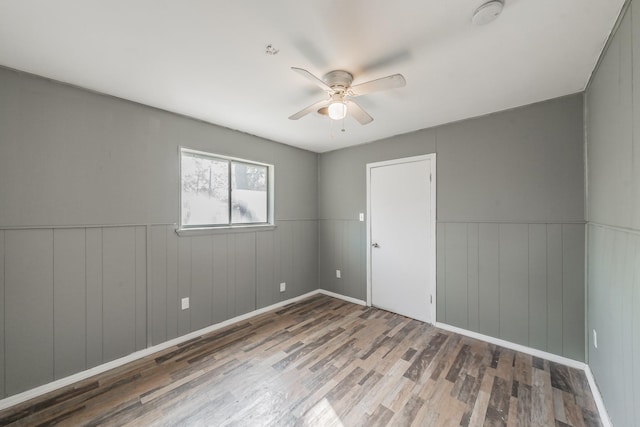 unfurnished room featuring hardwood / wood-style flooring and ceiling fan