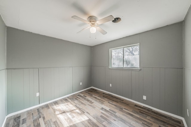 empty room featuring ceiling fan and hardwood / wood-style flooring