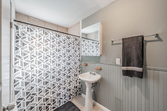 bathroom with tile patterned floors and a shower with shower curtain