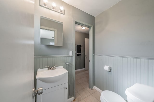 bathroom with tile patterned floors, vanity, and toilet