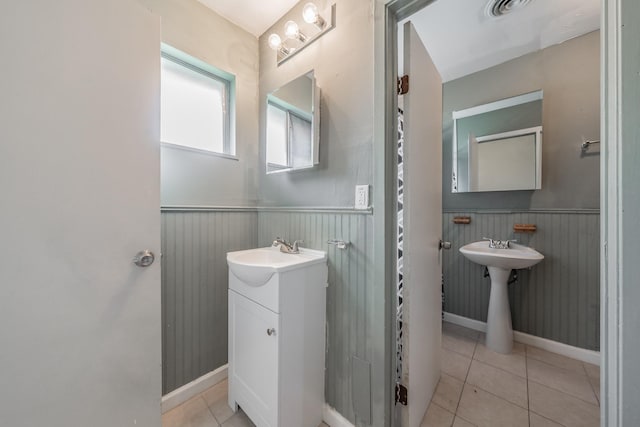 bathroom with tile patterned flooring and dual sinks