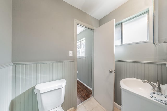 bathroom with hardwood / wood-style flooring and toilet