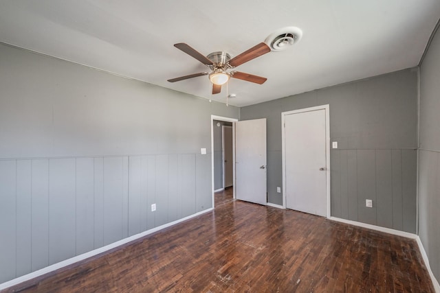 unfurnished bedroom featuring dark hardwood / wood-style flooring and ceiling fan